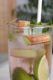 Glass of tasty rhubarb cocktail with lime, closeup
