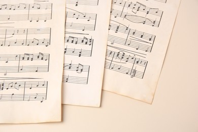 Photo of Sheets of paper with different notes on beige background, closeup