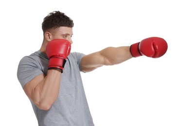 Photo of Man in boxing gloves fighting on white background