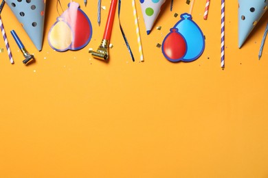 Photo of Flat lay composition with party items on orange background, Space for text