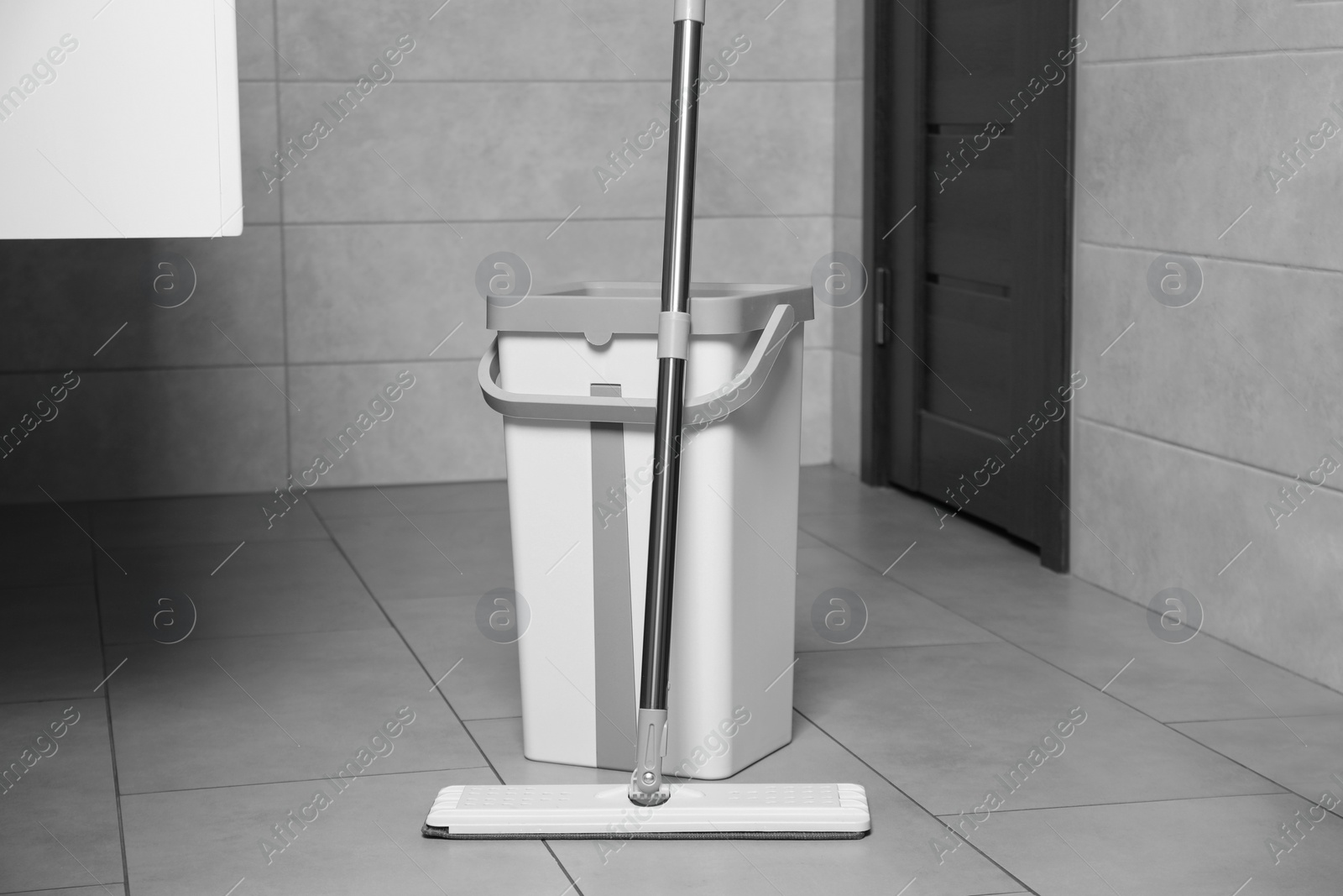 Photo of White mop and bucket in public toilet