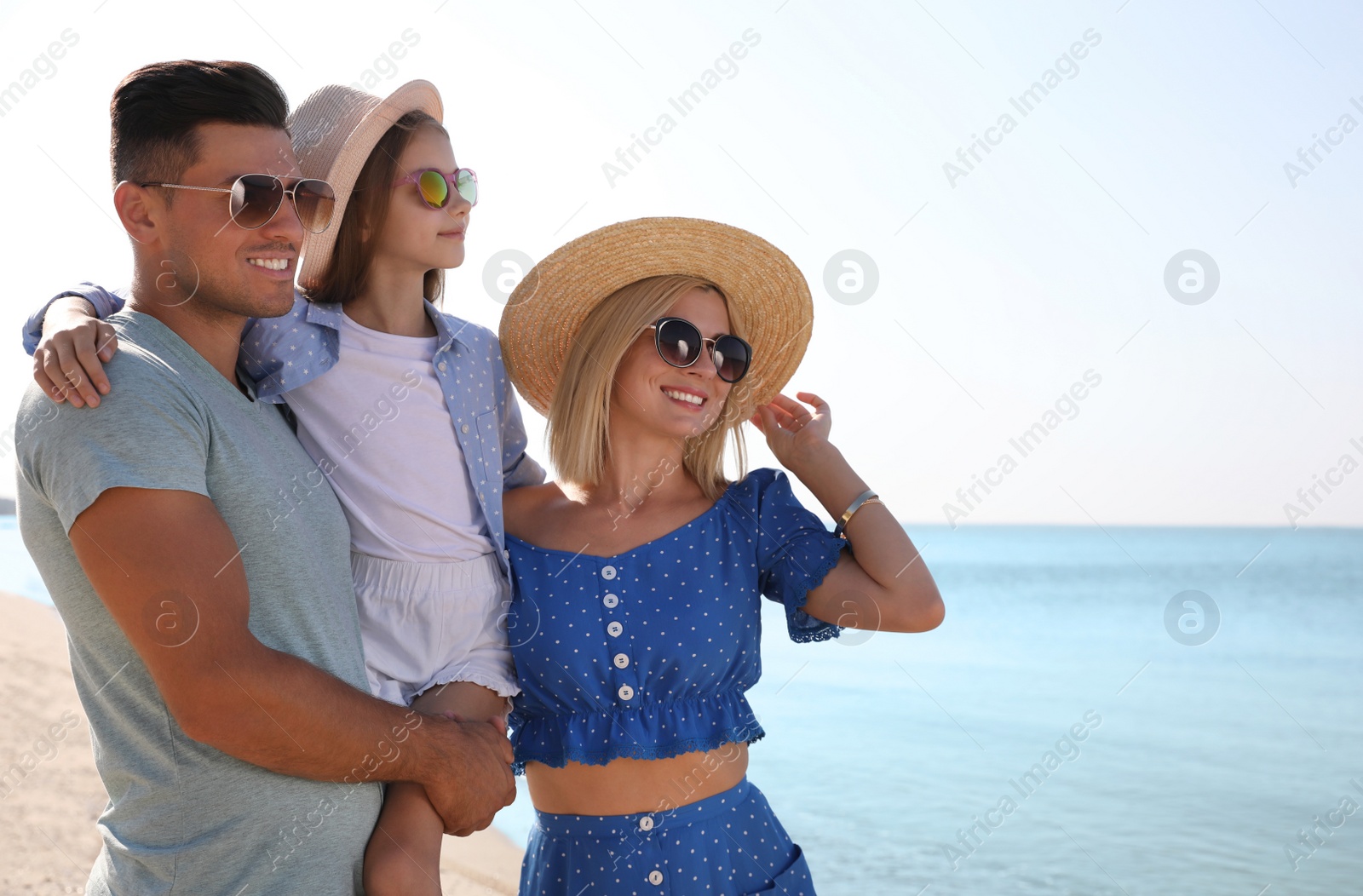 Photo of Happy family at beach on sunny summer day