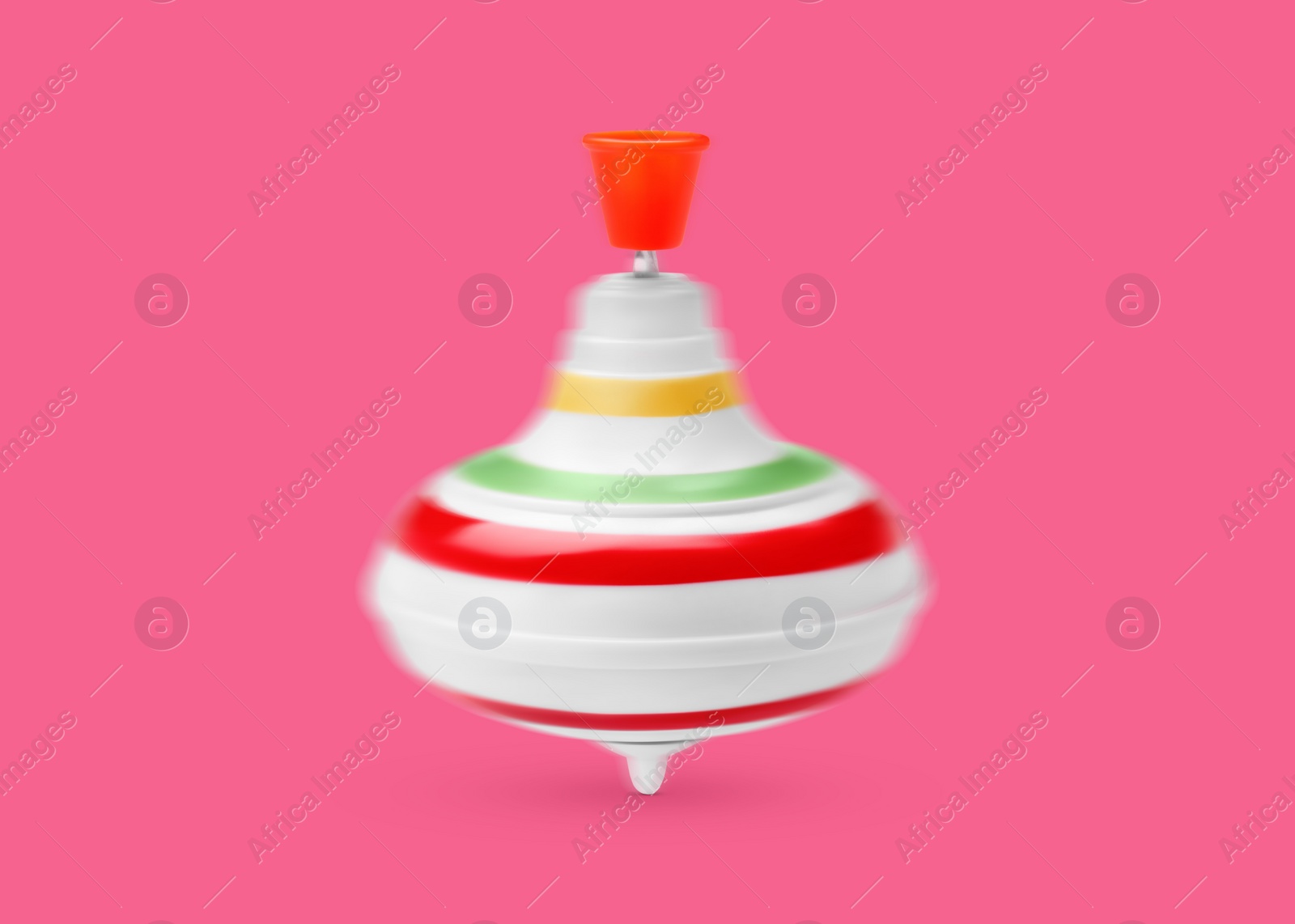 Image of One spinning top in motion on pink background. Toy whirligig