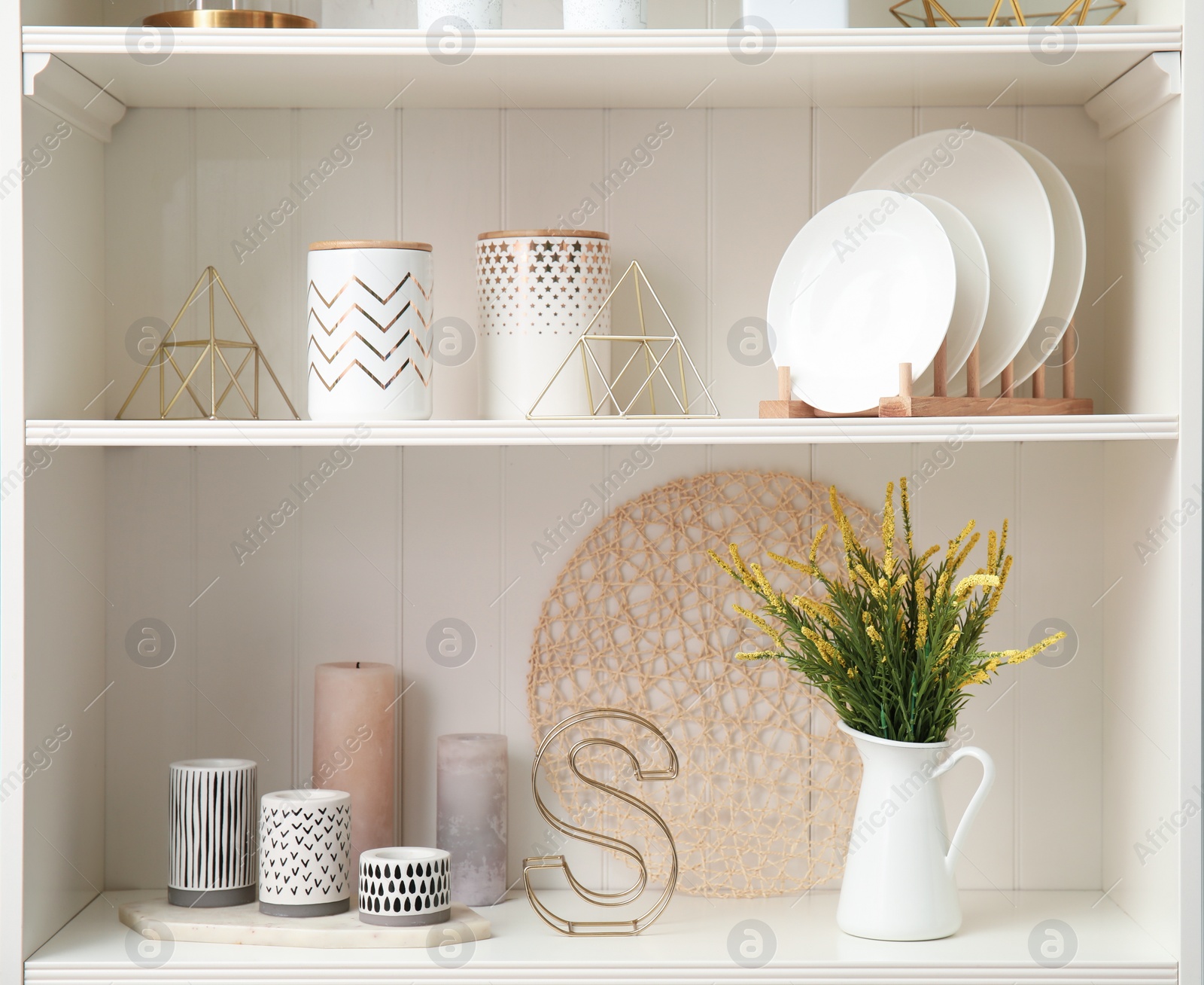 Photo of White shelving unit with dishes and different decorative stuff