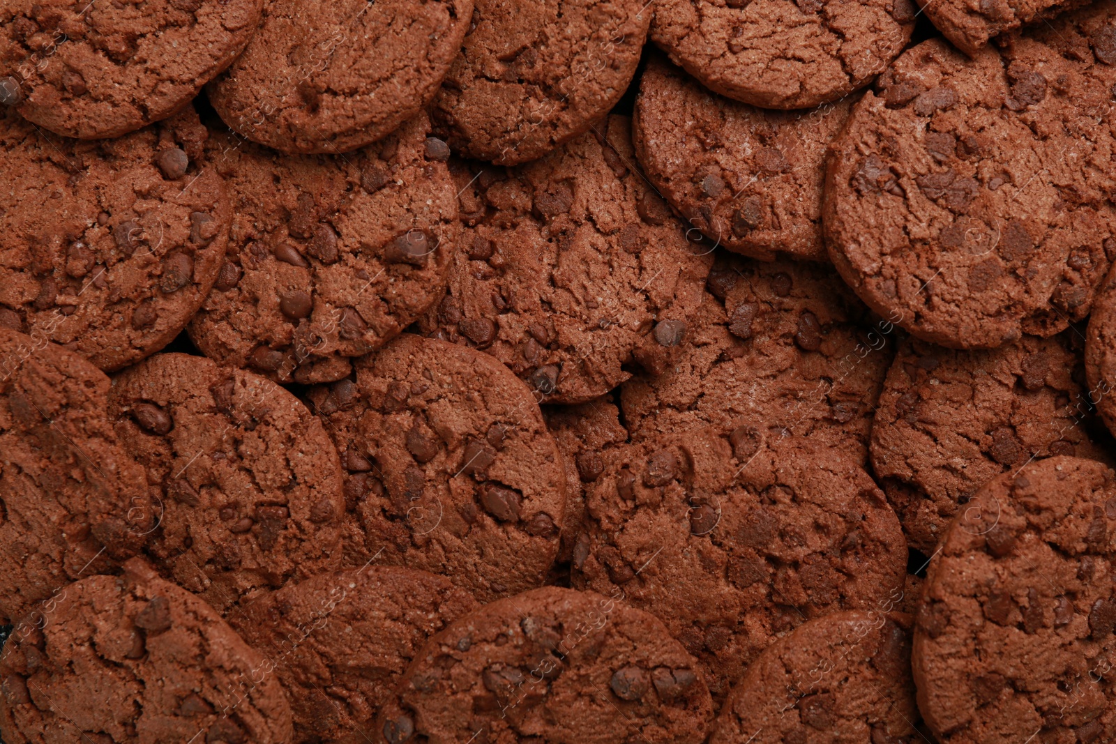 Photo of Tasty chocolate cookies as background, top view