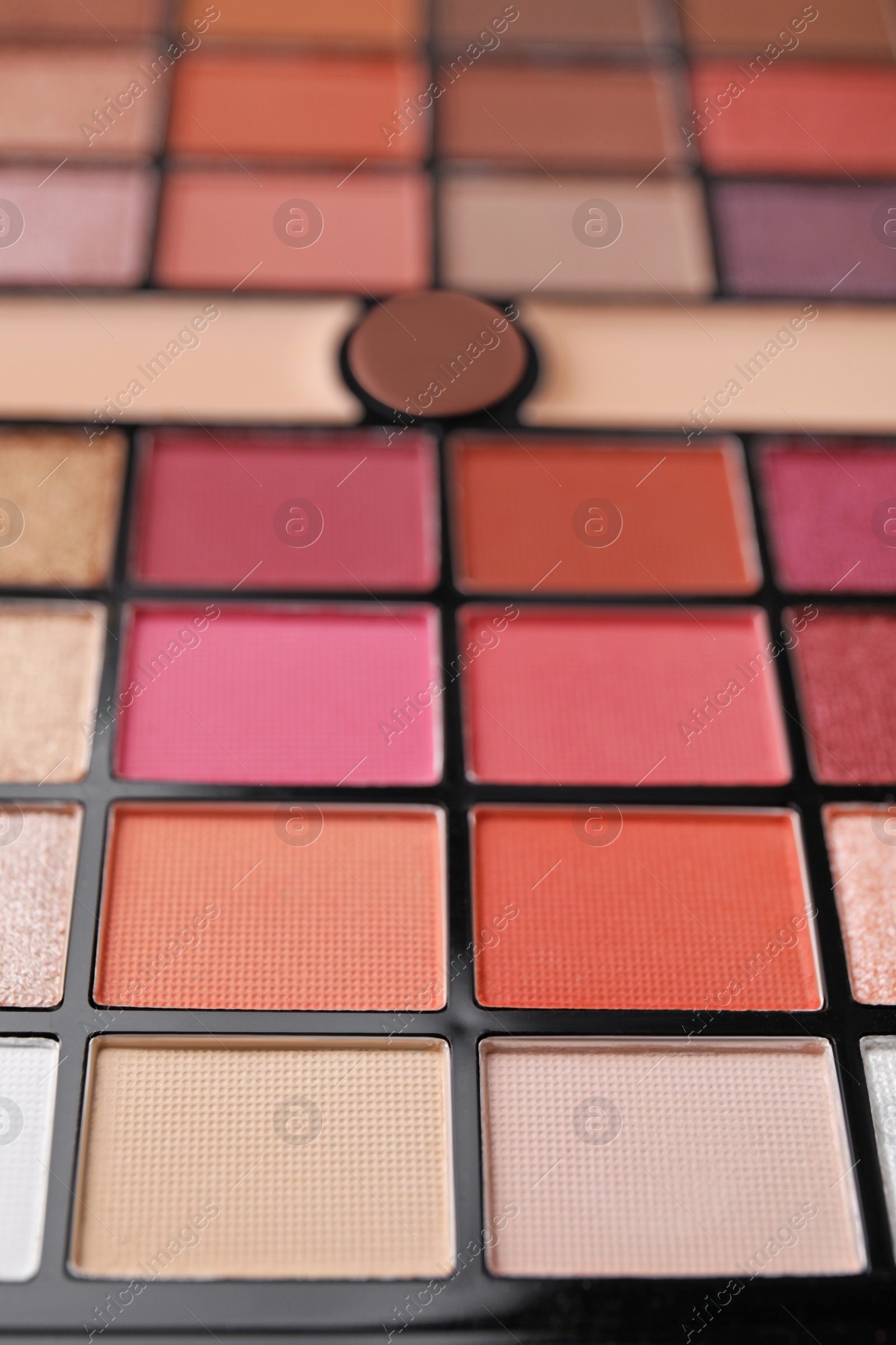 Photo of Beautiful eyeshadow palette as background, closeup. Professional cosmetic product