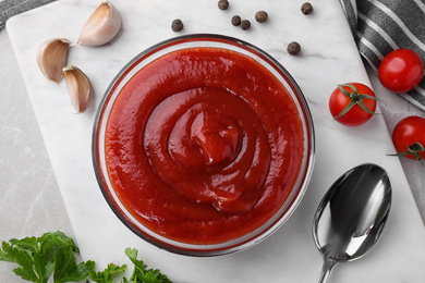 Photo of Flat lay composition with tomato sauce on white board