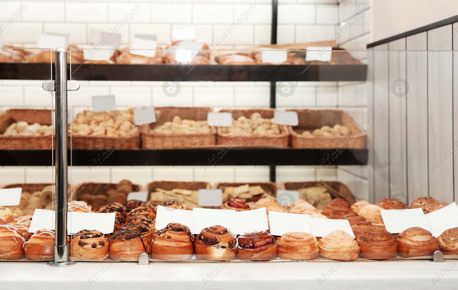 Photo of Showcase with different pastries in bakery shop