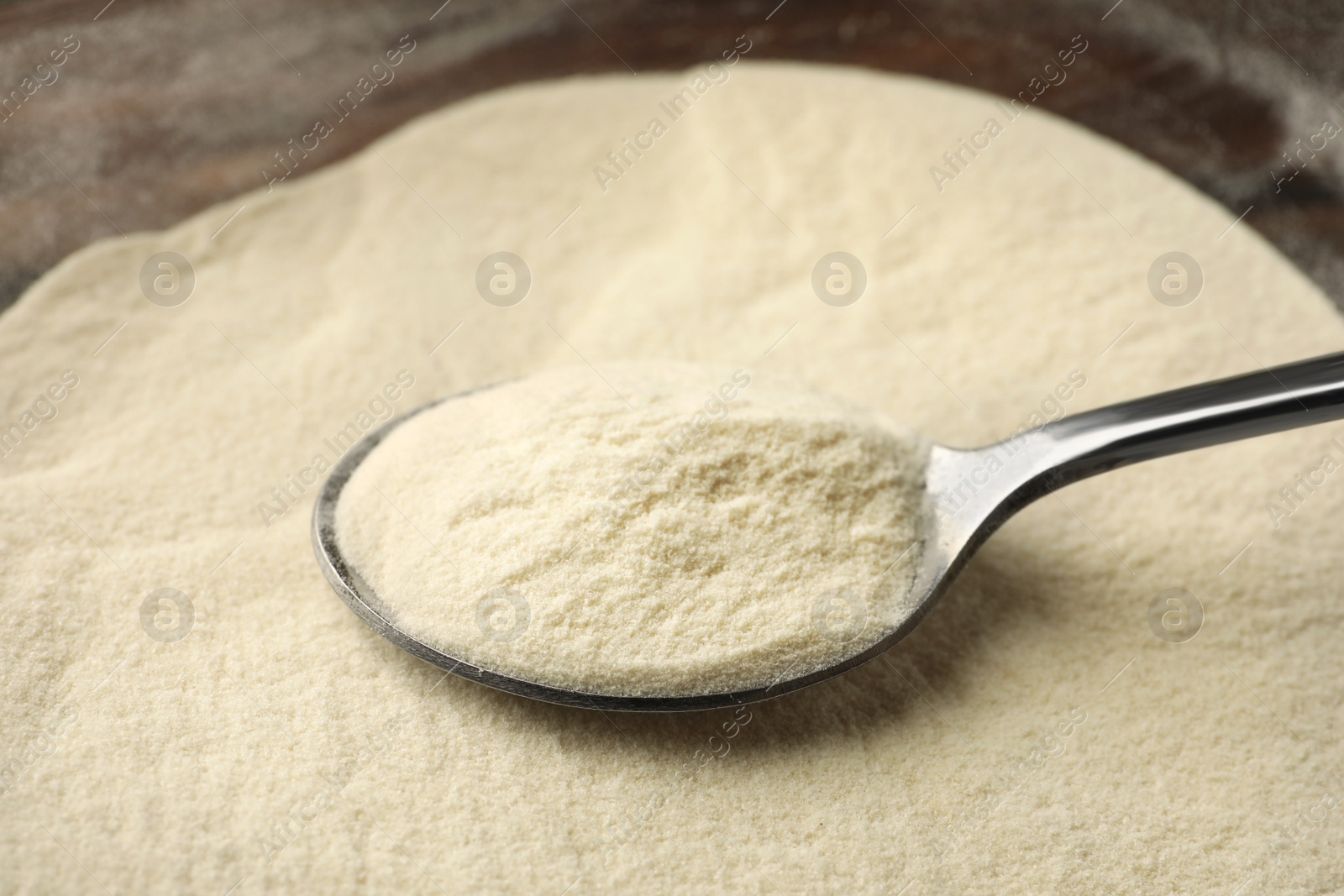 Photo of Organic agar-agar powder and spoon on table, closeup