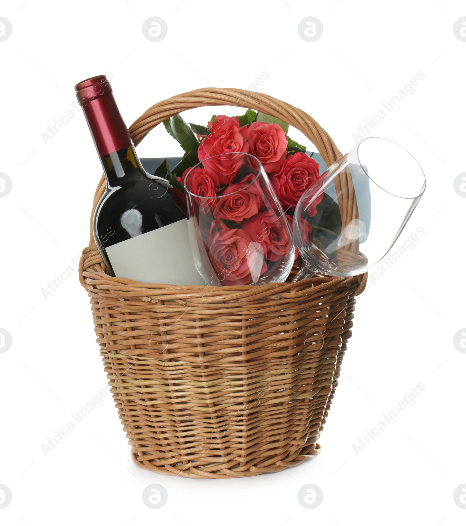 Photo of Wicker basket full of presents isolated on white