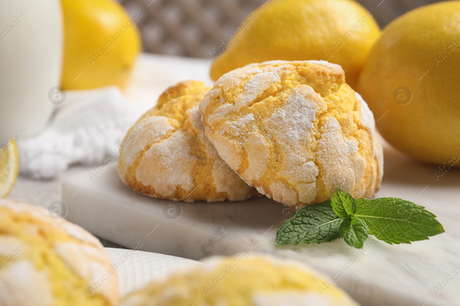 Photo of Delicious fresh lemon cookies and mint on table, closeup