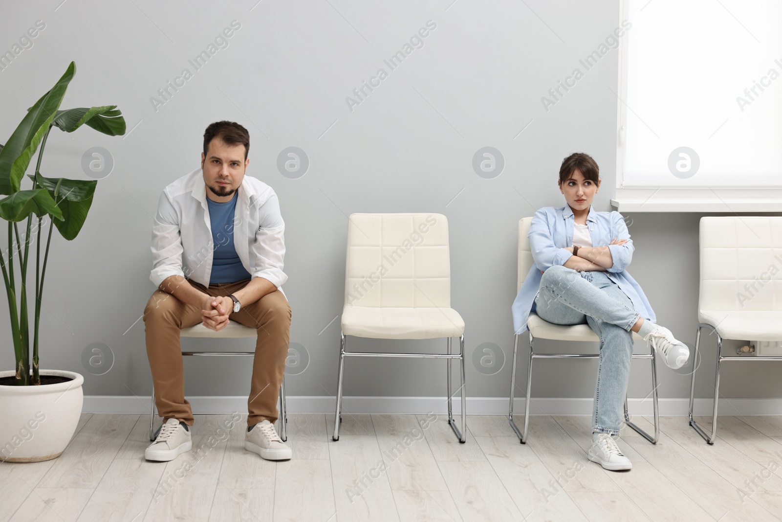 Photo of Man and woman waiting for appointment indoors