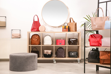 Photo of Collection of stylish woman's bags in modern store