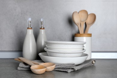 Photo of Set of different cooking utensils on grey countertop in kitchen