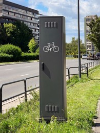 Public bicycle repair station near road in city