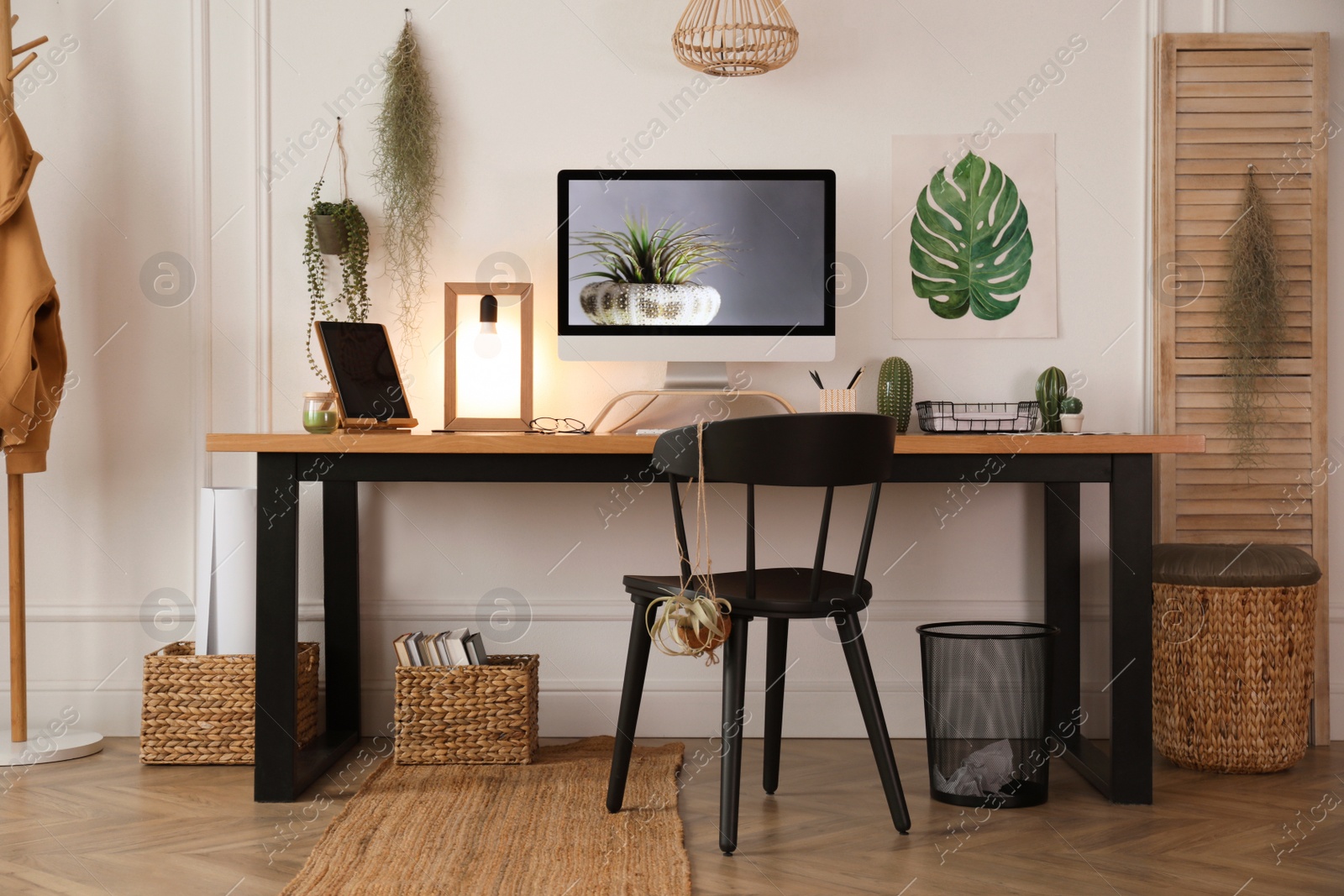 Photo of Modern workplace with computer in room. Interior design