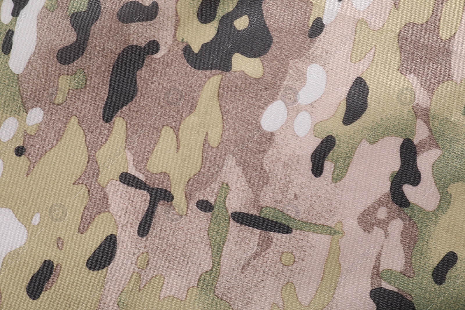 Photo of Texture of camouflage fabric as background, top view