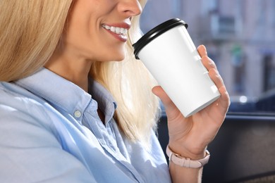 Photo of To-go drink. Woman drinking coffee in car, closeup