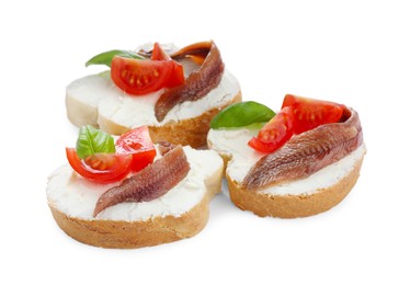 Photo of Delicious sandwiches with cream cheese, anchovies, tomatoes and basil on white background