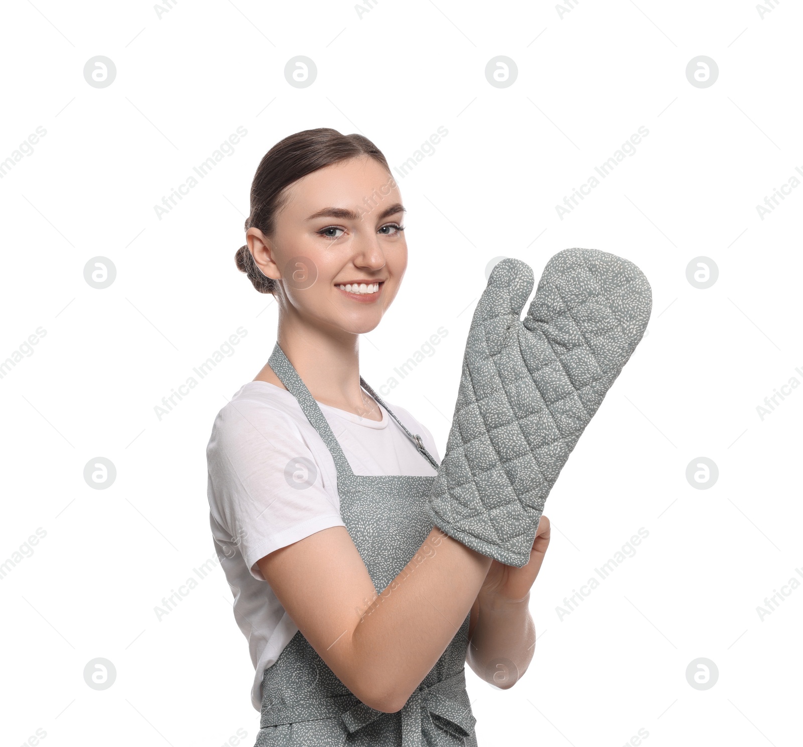 Photo of Beautiful young woman in clean apron with pattern and oven glove on white background