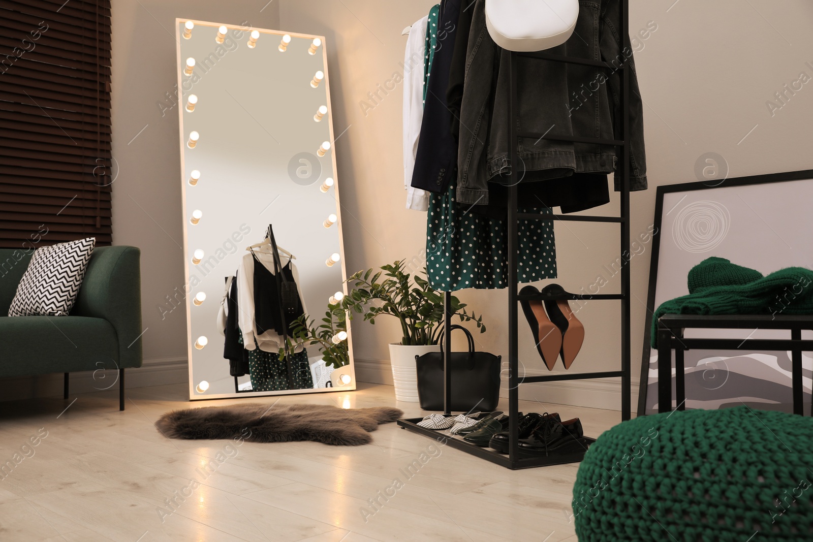 Photo of Modern dressing room interior with clothing rack and mirror