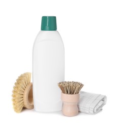 Photo of Bottle of cleaning product, rag and brushes isolated on white