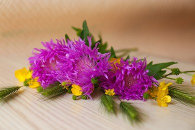 Bouquet of beautiful wildflowers on wooden table, closeup