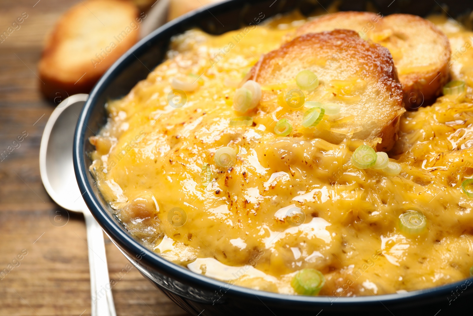 Photo of Tasty homemade French onion soup in bowl, closeup