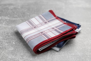 Photo of New stylish handkerchiefs on light grey table