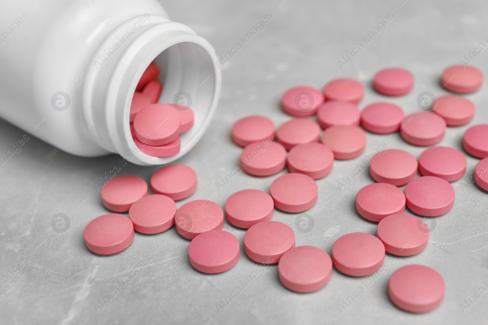 Photo of Bottle with pills on light background