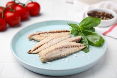 Photo of Canned mackerel fillets served on white tiled table, closeup