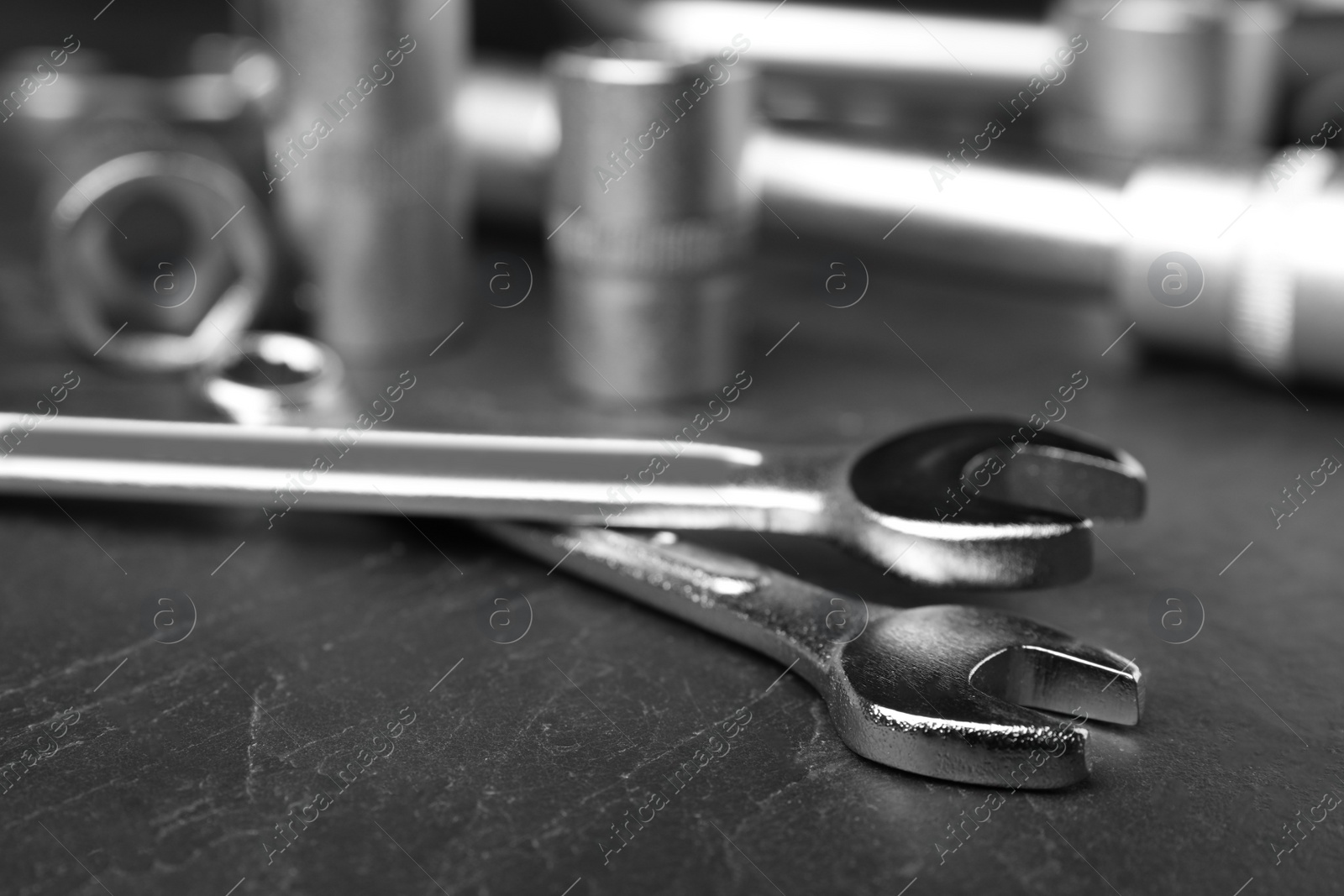 Photo of Auto mechanic's tools on grey background, closeup