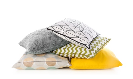 Photo of Pile of different colorful pillows on white background