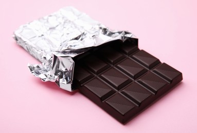 One tasty chocolate bar on pink background