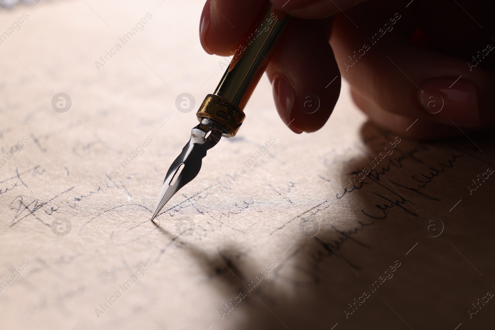 Photo of Woman writing letter with fountain pen, closeup