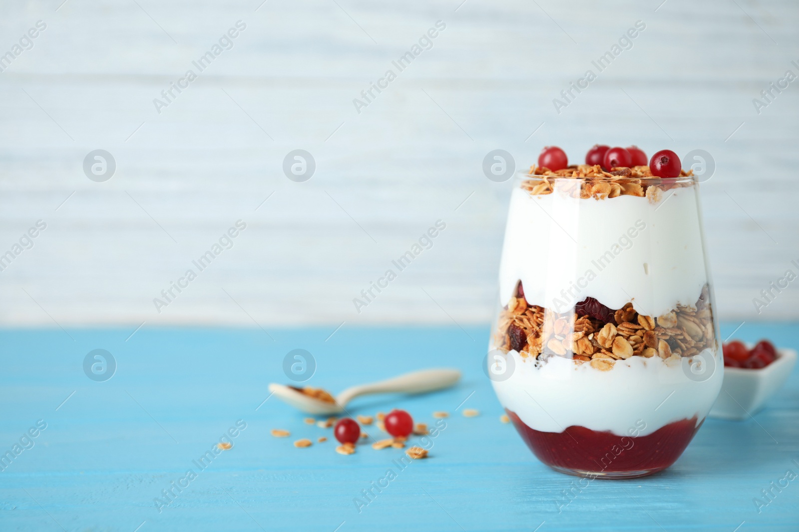 Photo of Tasty homemade granola served on blue wooden table, space for text. Healthy breakfast