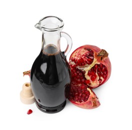 Photo of Tasty pomegranate sauce in bottle and fruits isolated on white