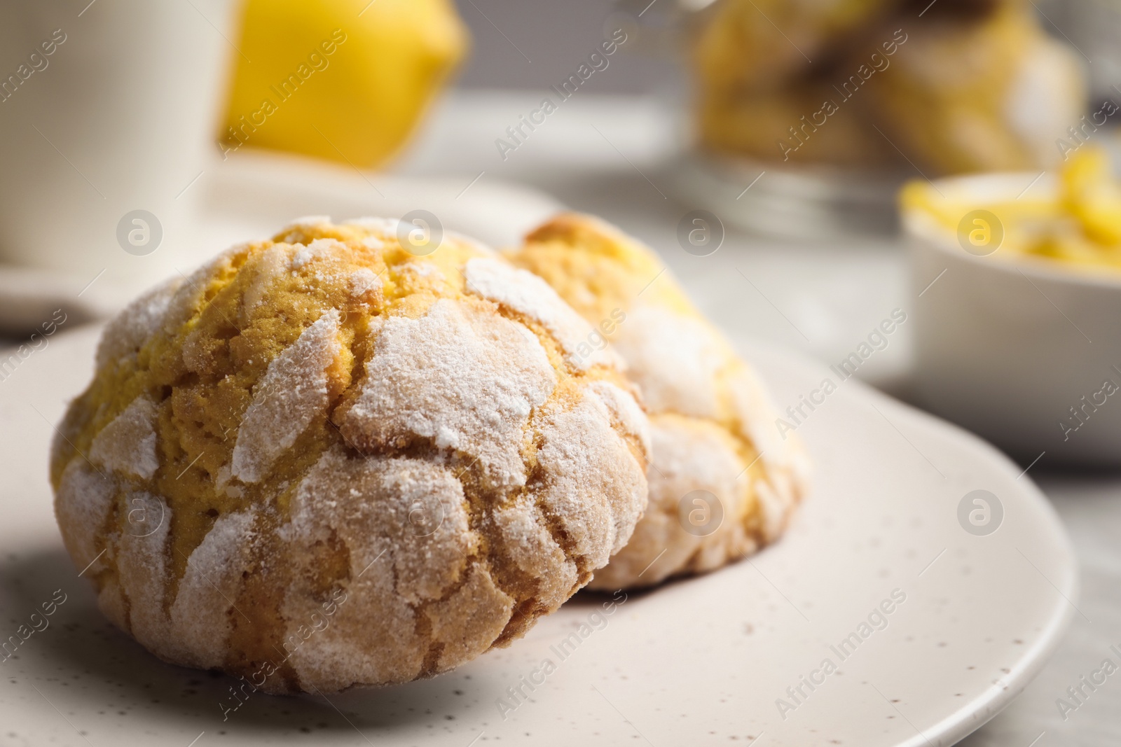 Photo of Plate with delicious lemon cookies on table, closeup