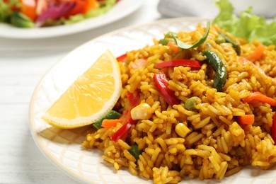 Photo of Delicious rice pilaf with vegetables on white table, closeup