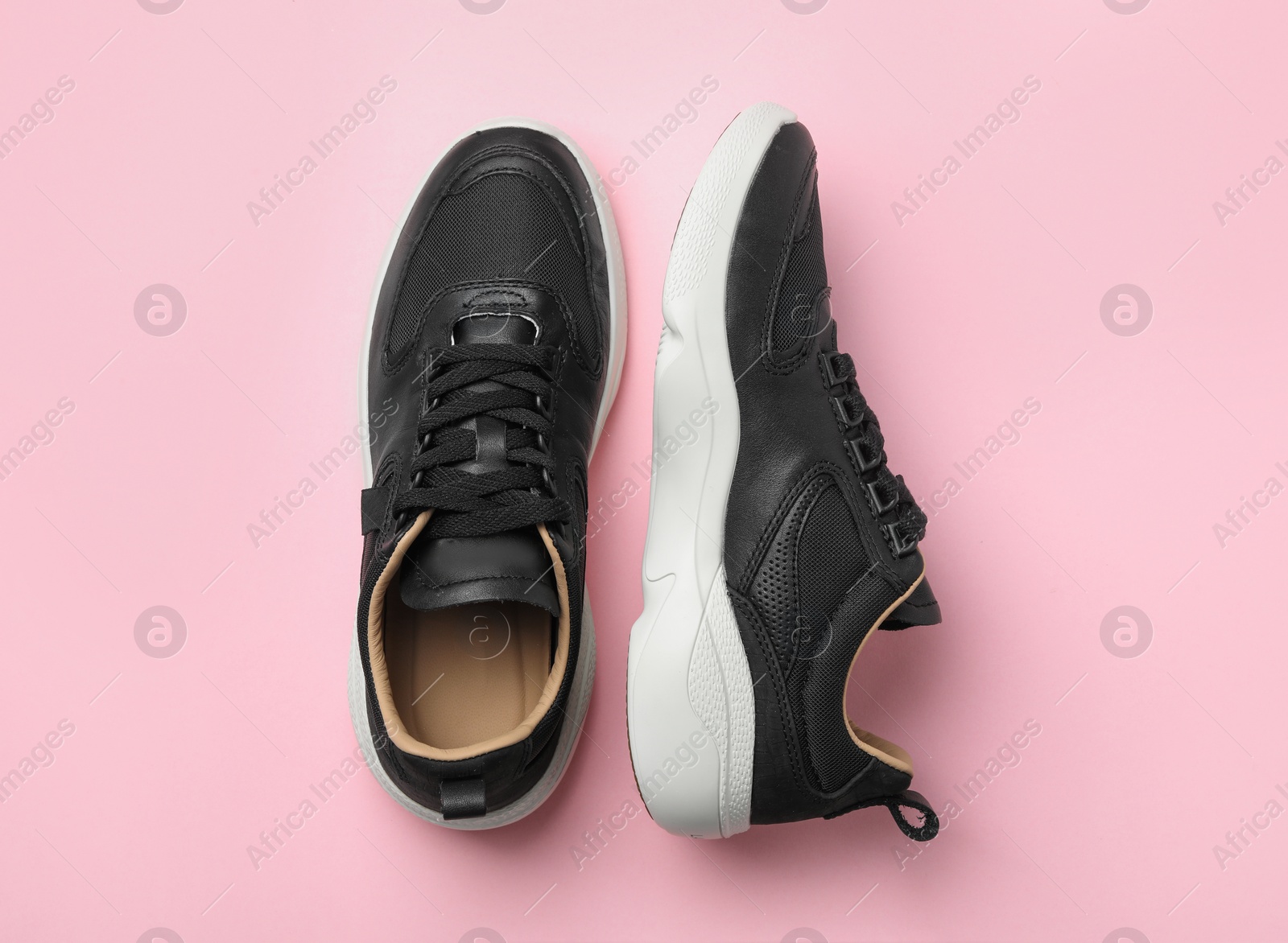 Photo of Pair of stylish shoes on pink background, top view