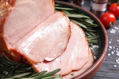 Photo of Delicious cooked ham served on wooden table, closeup
