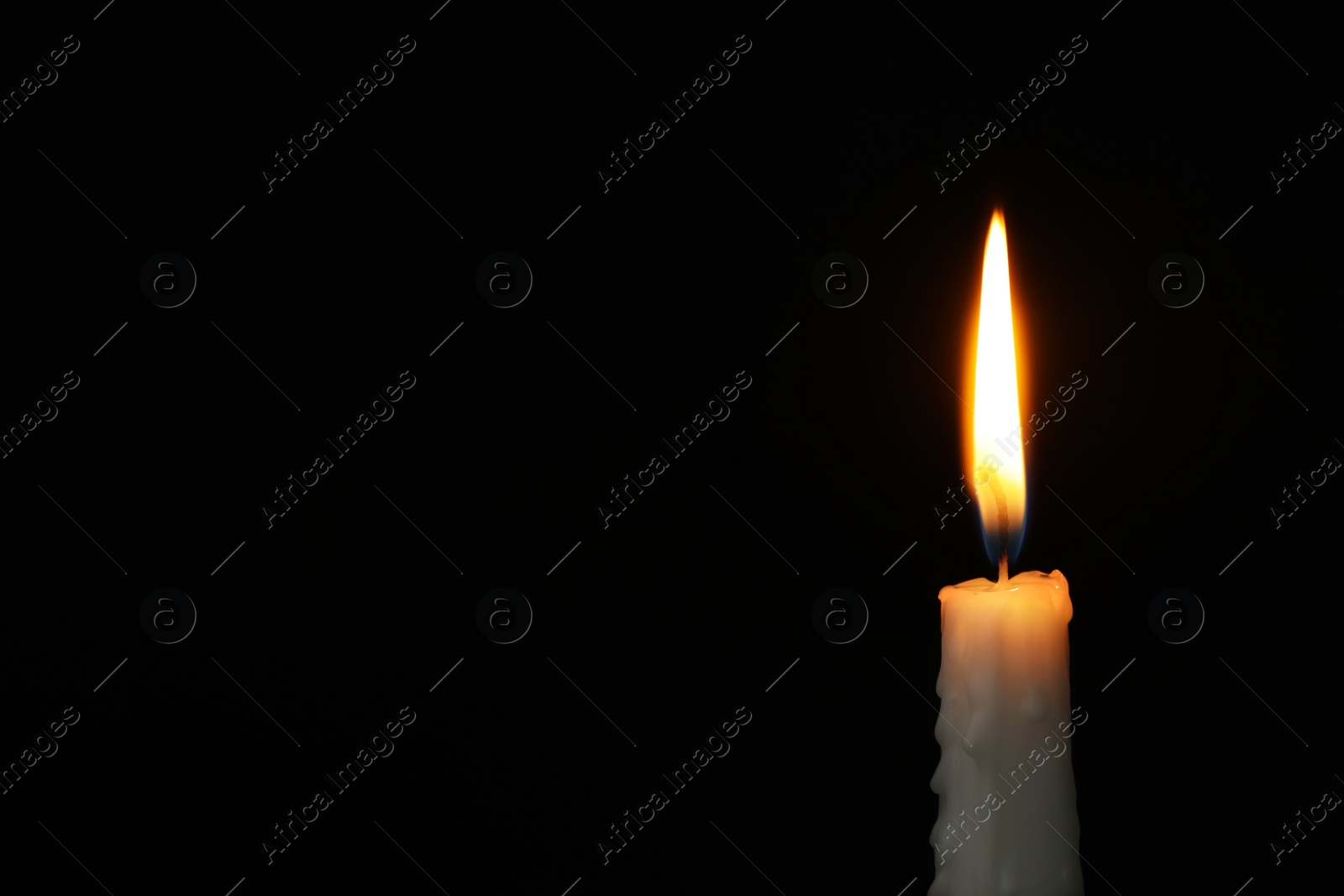 Photo of Burning candle on dark background, space for text. Symbol of sorrow