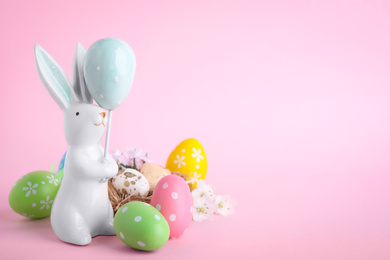 Composition with Easter bunny figure on pink background. Space for text