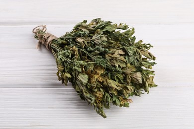 Bunch of dry parsley on white wooden table