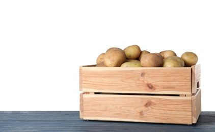 Photo of Wooden crate full of fresh raw potatoes on white background
