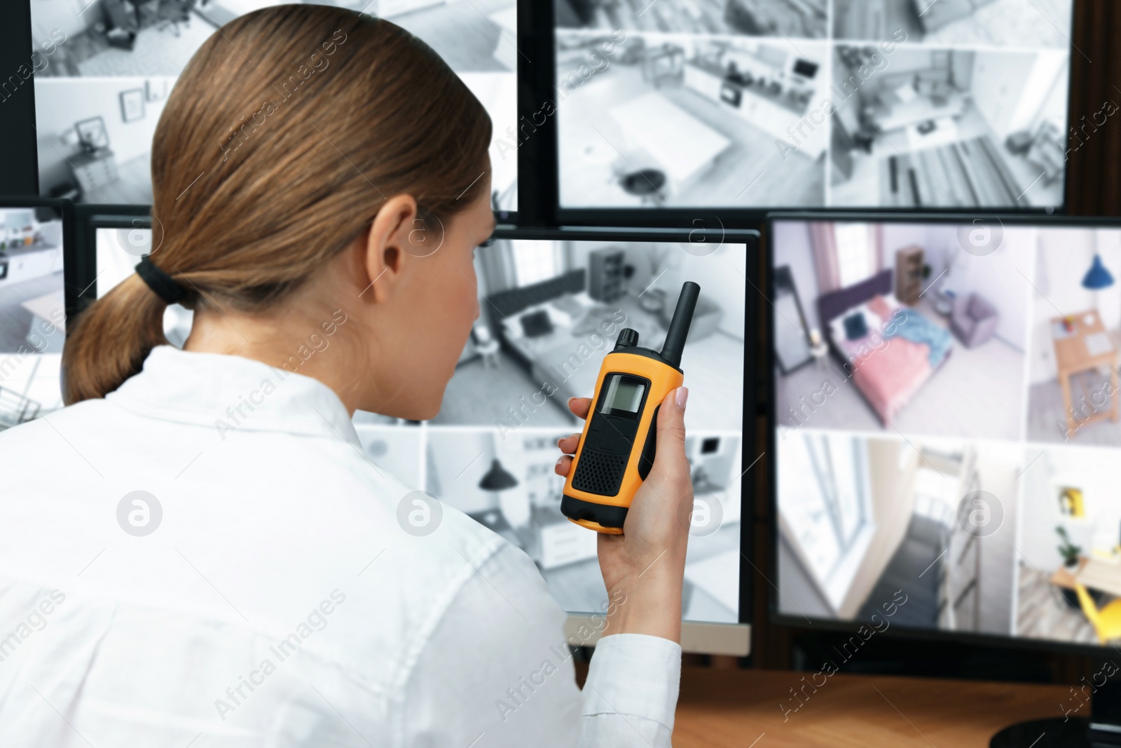 Photo of Security guard using portable transmitter at workplace