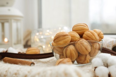 Delicious nut shaped cookies with boiled condensed milk and Christmas decor on window sill. Space for text