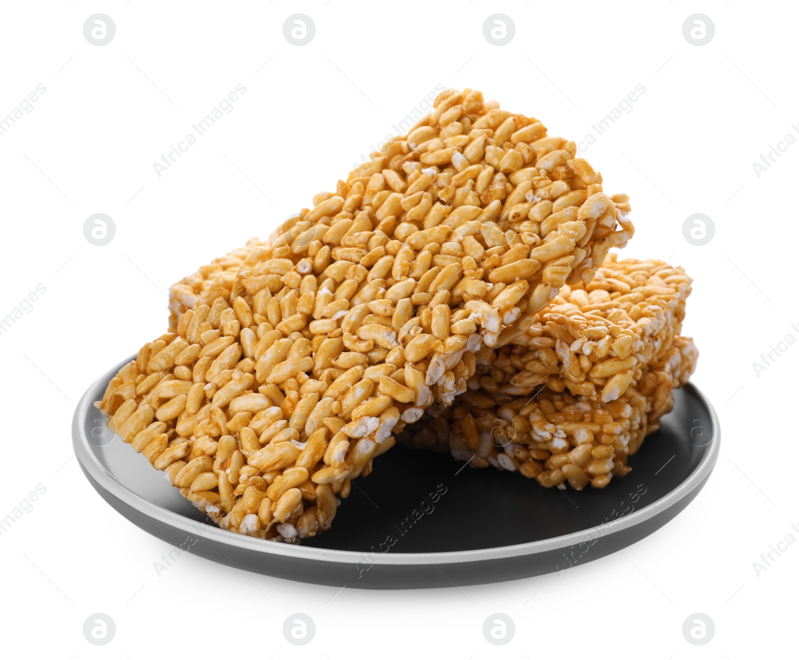 Photo of Plate with puffed rice bars (kozinaki) on white background