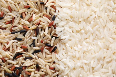 Photo of Brown and polished rice as background, top view