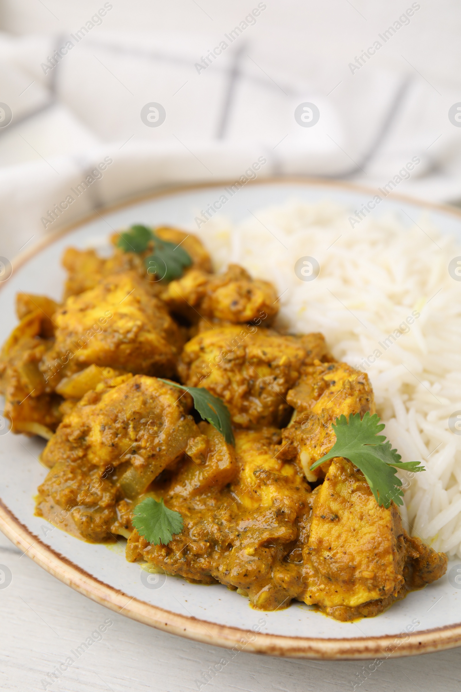 Photo of Delicious chicken curry with rice on table, closeup